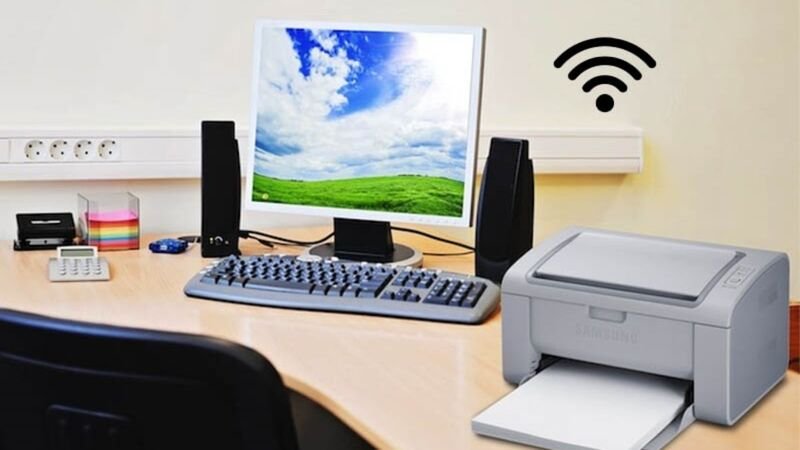 Người dùng thao tác in ấn không dây từ laptop đến máy in kết nối wifi