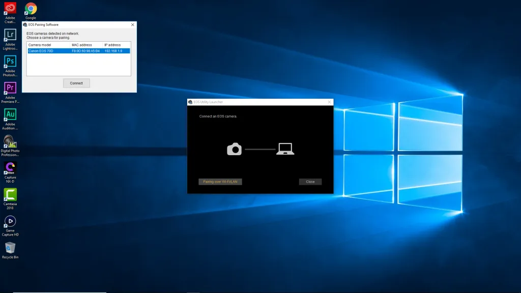 Người dùng đang kết nối máy ảnh Canon với laptop bằng cáp USB