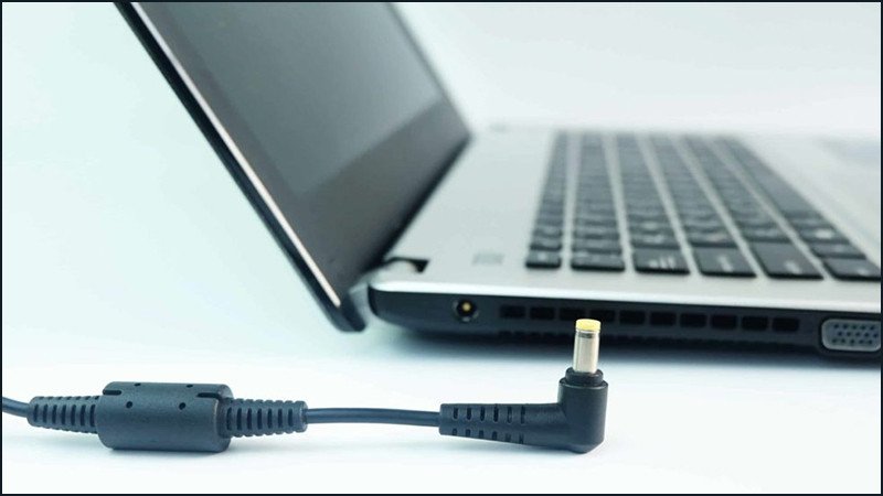 Người dùng đang tắt nguồn laptop và rút dây sạc trước khi tiến hành vệ sinh máy tính laptop